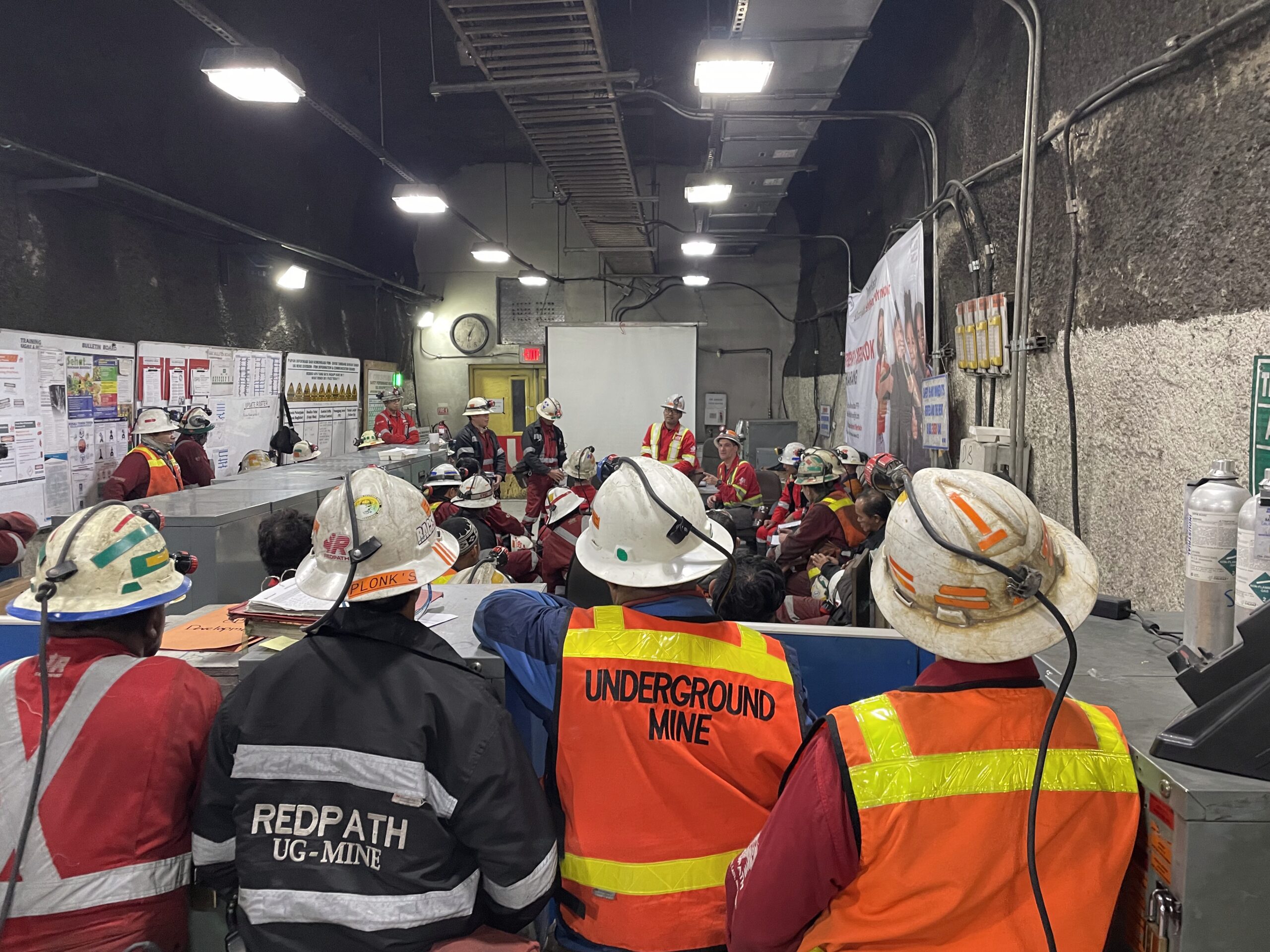 An underground mining crew at a pre-start meeting